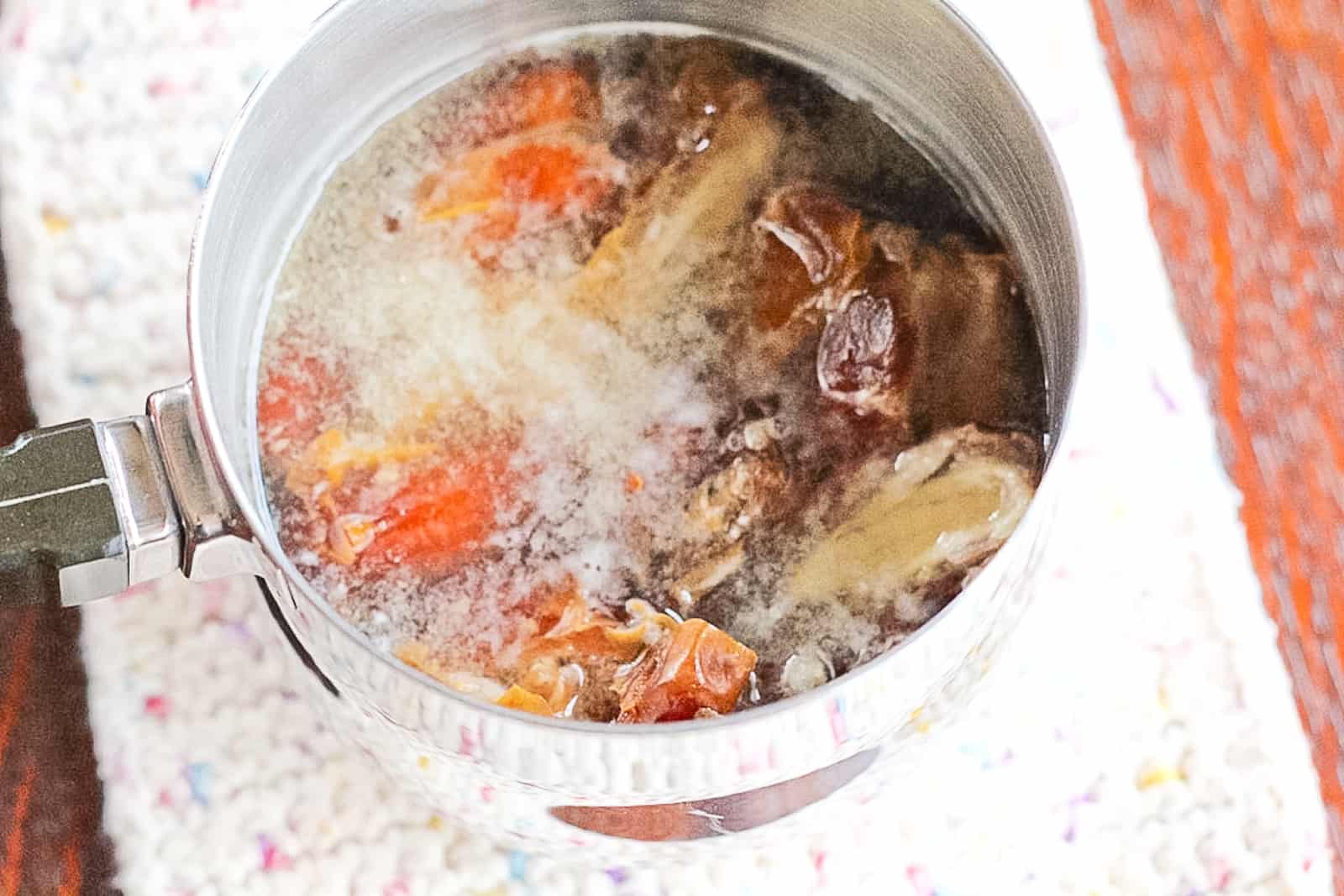 Medjool dates soaking in hot water to make date paste. 