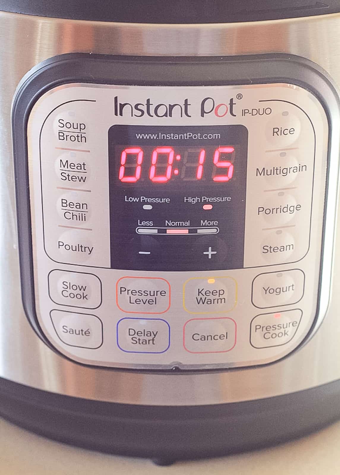 Front of the Instant Pot with 15 minutes of cook time listed on high pressure.