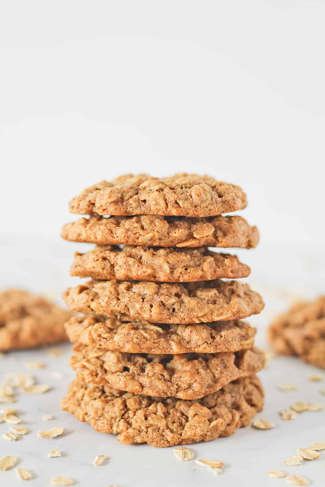 Vegan Almond Butter Cookies in a stack surrounded by oats.