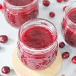 Instant Pot Cranberry Sauce surrounded by fresh cranberries.