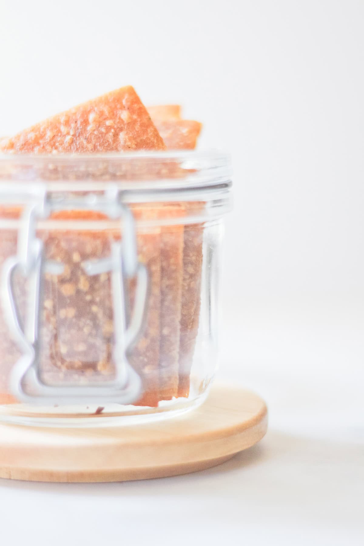 Einkorn Sourdough Discard Crackers in glass container.