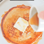 Sourdough pancakes with butter and syrup being poured overtop.