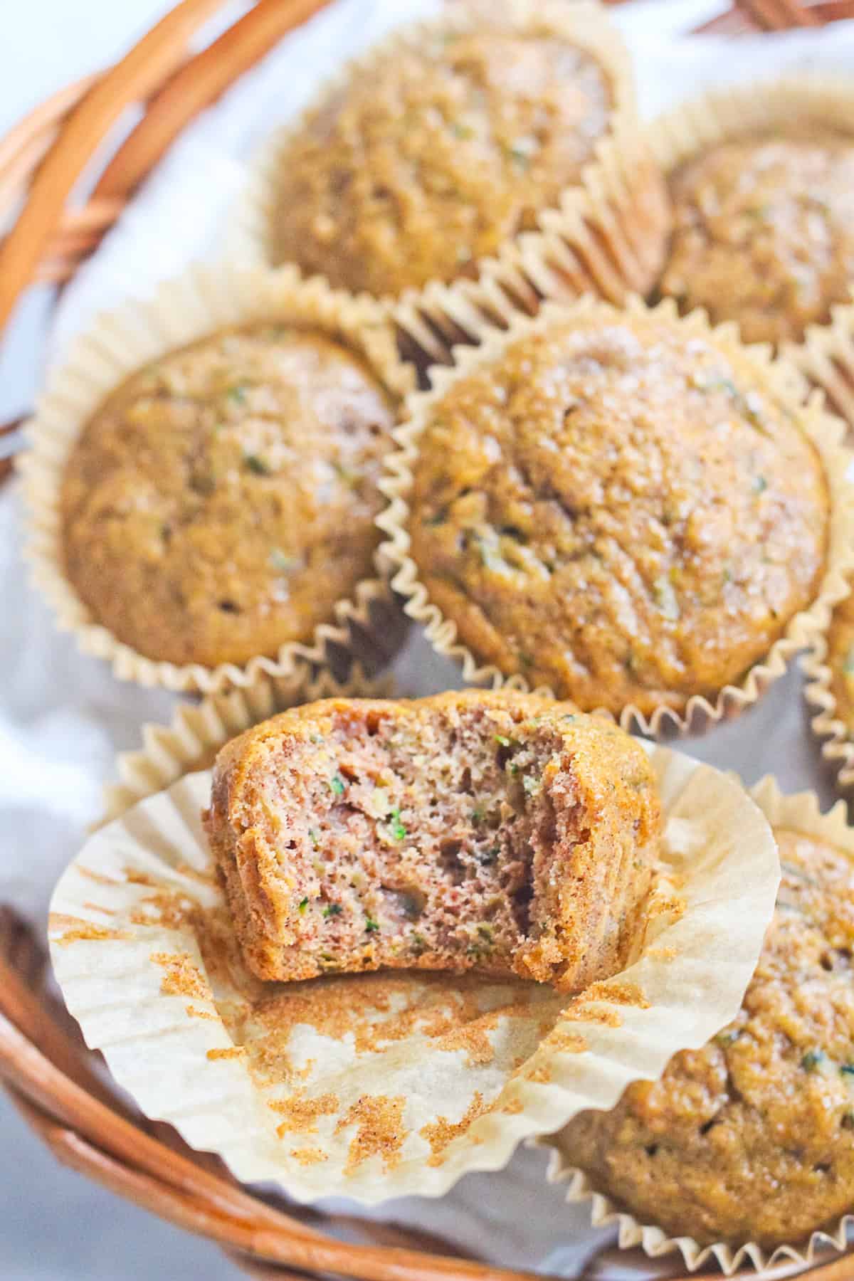 Zucchini muffins with a bite taken out of one.